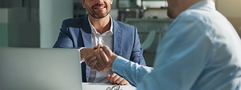 Shot of two businessmen shaking hands in an office